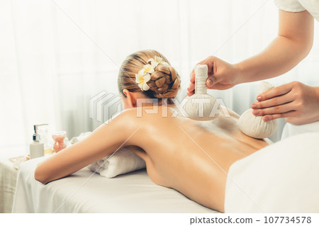Hot herbal ball spa massage body treatment at day spa . Quiescent Hot herbal ball spa massage body treatment at day spa . Quiescent 107734578