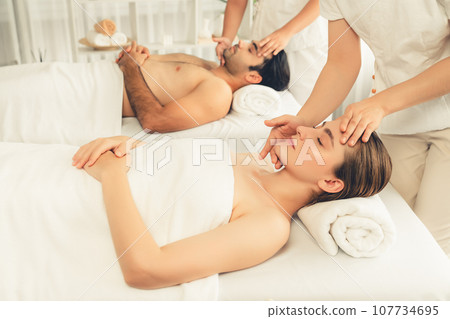 Caucasian couple enjoying relaxing anti-stress head massage. Quiescent Caucasian couple enjoying relaxing anti-stress head massage. Quiescent 107734695