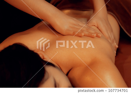 Caucasian man customer enjoying relaxing anti-stress massage. Quiescent Caucasian man customer enjoying relaxing anti-stress massage. Quiescent 107734701
