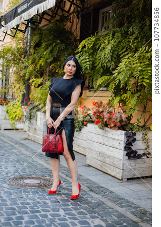 Confident business lady in stylish wear and high heels posing outdoors 107734856