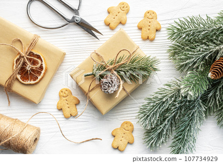 Christmas gifts, gingerbread cookies, decorations with christmas tree. Christmas gifts, gingerbread cookies, decorations with christmas tree. 107734929