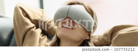 Relaxed woman enjoys eye massage wearing special goggles Relaxed woman enjoys eye massage wearing special goggles 107735212