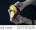 Asian woman is peeling Sweet Potatoes, closed up shot. 107735476