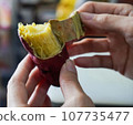 Asian woman is peeling Sweet Potatoes, closed up shot. 107735477