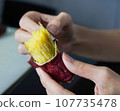 Asian woman is peeling Sweet Potatoes, closed up shot. 107735478