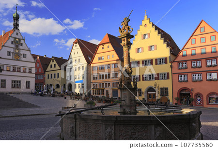 Markplatz with traditional houses and fountain on the foreground, Rothenburg ob der Tauber, Central Franconia in Bavaria, Germany Markplatz with traditional houses and fountain on the foreground, Rothenburg ob der Tauber, Central Franconia in Bavaria, Germany 107735560