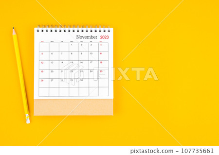 November2023 desk calendar and wooden pencil on yellow background. Time planning. November2023 desk calendar and wooden pencil on yellow background. Time planning. 107735661
