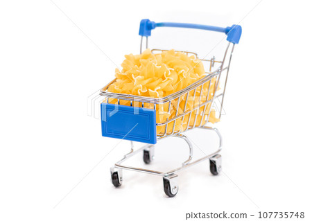 Uncooked Fusilli Pasta in Small Shopping Cart Isolated on White 107735748