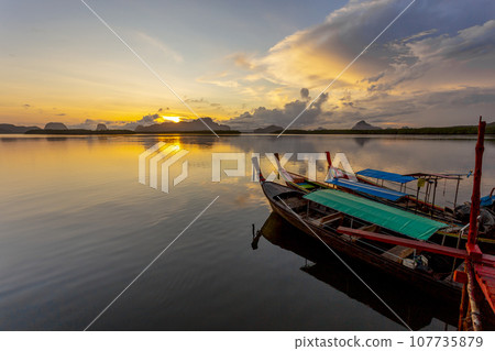 Ban Sam Chong Tai and colorful sunrises that emerges behind the giant limestone mountains, Thailand 107735879