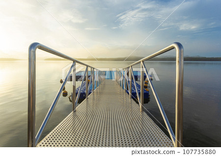 Tourism port in the colorful sunrise at Ban Sam Chong Tai, Phang nga, Thailand. 107735880