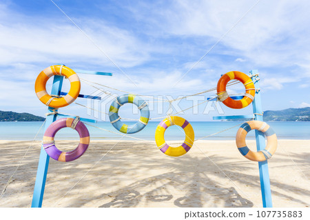 The Artificial swim ring rubber on the beach with blue sky in summer. 107735883