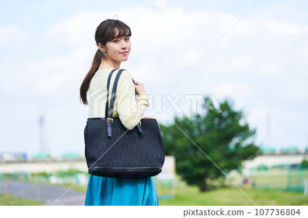 Young woman blue sky park 107736804