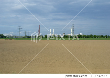 field with production in the background 107737463