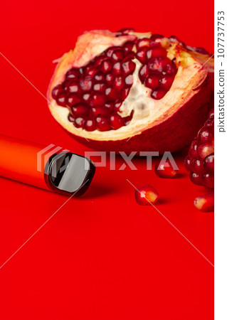 Electronic cigarette with pomegranate flavor on red background 107737753