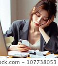 A woman who is busy organizing bills. A housewife who is busy calculating receipts and is struggling with her household finances. 107738053