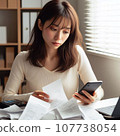 A woman who is busy organizing bills. A housewife who is busy calculating receipts and is struggling with her household finances. 107738054