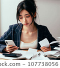 A woman who is busy organizing bills. A housewife who is busy calculating receipts and is struggling with her household finances. 107738056