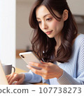 A career woman who operates a smartphone and a computer at the same time. A working Japanese woman with long hair. 107738273