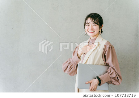 Stylish designer businesswoman with a laptop Stylish designer businesswoman with a laptop 107738719