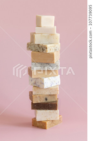 Beige handmade soap bars on light pink close up. Natural herbal product Beige handmade soap bars on light pink close up. Natural herbal product 107739095