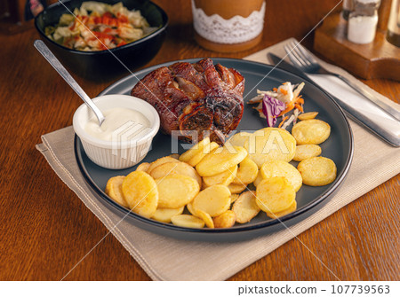 Roasted pork knuckle with potatoes Roasted pork knuckle with potatoes 107739563