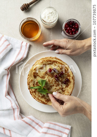 Large pancakes on light stone background Large pancakes on light stone background 107739875