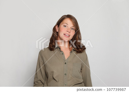 Happy young woman in green shirt on white background Happy young woman in green shirt on white background 107739987
