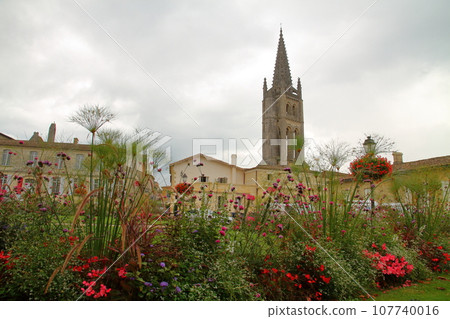 The spire of the Monolith church is the symbol of Saint-Émilion, a world cultural heritage site and famous wine region near Bordeaux, France. 107740016