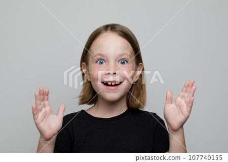 Happy excited surprised child girl on white background portrait 107740155