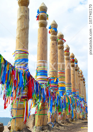 Hitching posts with ribbons of shamanism religion in Khuzhir, island Olkhon.  107740170