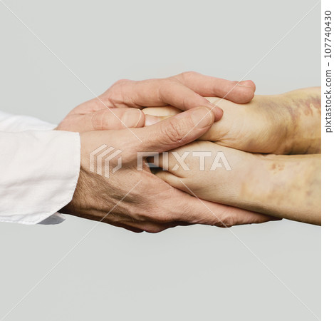Medical and social support. Doctor nand holding patient hand with trauma bruises Medical and social support. Doctor nand holding patient hand with trauma bruises 107740430