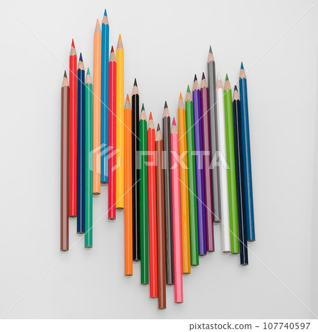 Colored pencils in the form of a wave on a white background 107740597