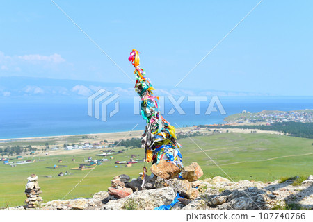 Hitching post with ribbons of shamanism religion in Khuzhir, island Olkhon. Hitching post with ribbons of shamanism religion in Khuzhir, island Olkhon. 107740766