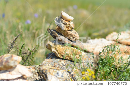 Rock balancing as a shamanism religion symbol in Olkhon island, Russia Rock balancing as a shamanism religion symbol in Olkhon island, Russia 107740770