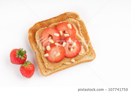 Sweet sandwich with strawberries and peanut butter on light background. Flat lay, copy space. Sweet sandwich with strawberries and peanut butter on light background. Flat lay, copy space. 107741750