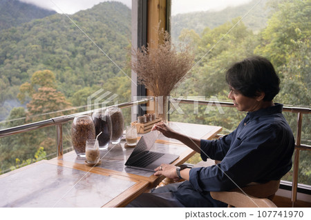 digital nomad concept asian freelancer man use laptop to work at mountain view of coffeeshop 107741970