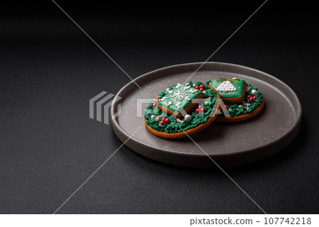 Beautiful festive Christmas gingerbread made by hand with decoration elements Beautiful festive Christmas gingerbread made by hand with decoration elements 107742218