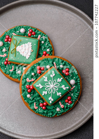 Beautiful festive Christmas gingerbread made by hand with decoration elements Beautiful festive Christmas gingerbread made by hand with decoration elements 107742227