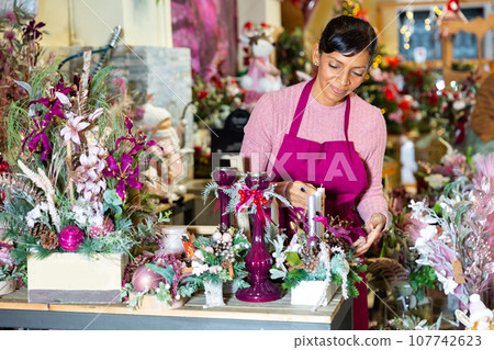 American female offering Christmas decorations 107742623