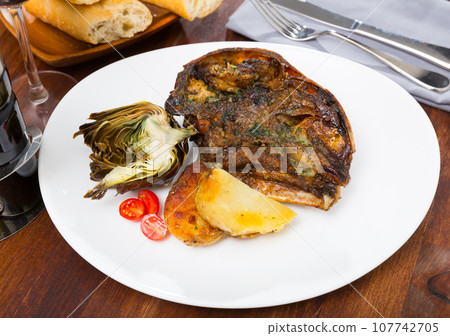Cabeza de cordero - spanish dish. Lamb head with artichoke, tomatoes and potatoes Cabeza de cordero - spanish dish. Lamb head with artichoke, tomatoes and potatoes 107742705