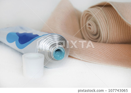 topical medication with roll bandage for first aid accident  107743065