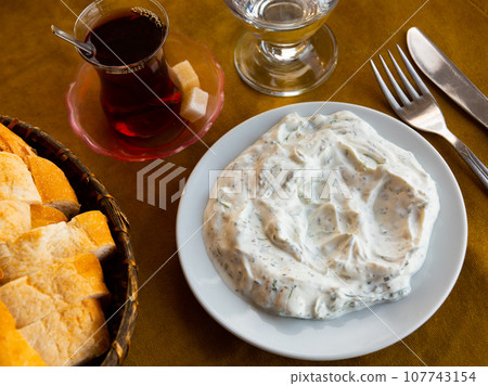 Tzatziki or cacik, cucumber and yogurt salad with mint closeup. Turkish cuisine Tzatziki or cacik, cucumber and yogurt salad with mint closeup. Turkish cuisine 107743154