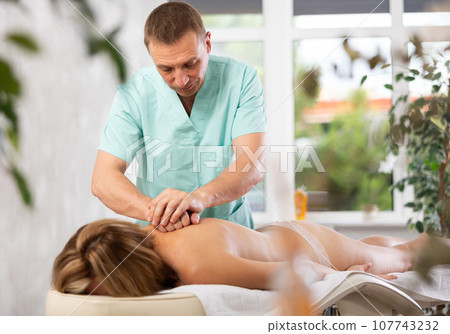 The masseur makes a massage to woman 107743232