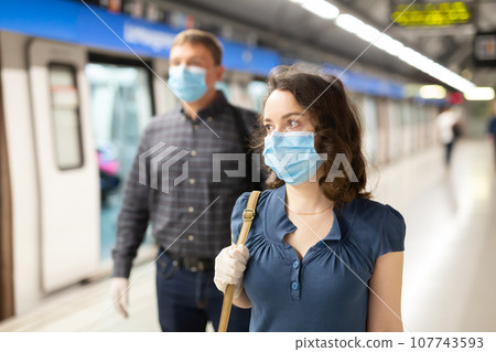 Metro passengers use personal protective Metro passengers use personal protective 107743593