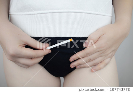 Bacterial Vaginosis. Vaginal pH. Girl shows sticks for measuring acid-base balance of genital organs. Self-diagnosis. Normal acidity level shown in colors and must be compared with the standard Bacterial Vaginosis. Vaginal pH. Girl shows sticks for measuring acid-base balance of genital organs. Self-diagnosis. Normal acidity level shown in colors and must be compared with the standard 107743778
