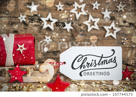Sled With Gift, Christmas Snowy Background With Text Christmas Greetings Sled With Gift, Christmas Snowy Background With Text Christmas Greetings 107744573