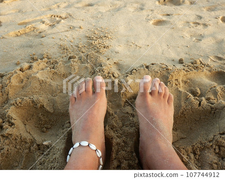 Feet in the sand on the beach Feet in the sand on the beach 107744912
