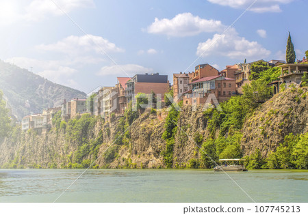 Houses on the edge of a cliff above the river Kura. Tbilisi, the historic city Houses on the edge of a cliff above the river Kura. Tbilisi, the historic city 107745213