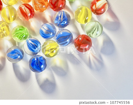 many marbles on white background 107745556