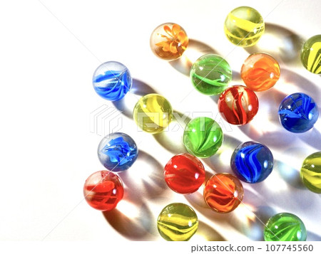 many marbles on white background 107745560